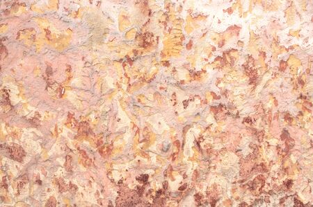 Closeup detail of rustic colonial style textured wall in Merida, Mexico with pastel shades of orange and redの写真素材