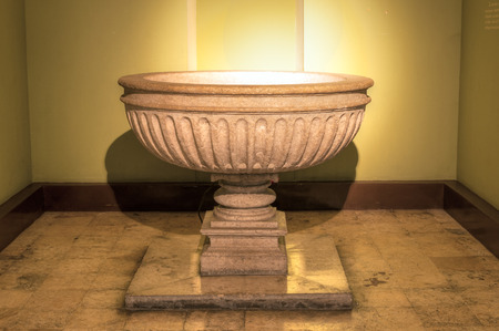 Illuminated stone baptismal font in Cathedral of Ildefonso in Merida, Mexicoの写真素材