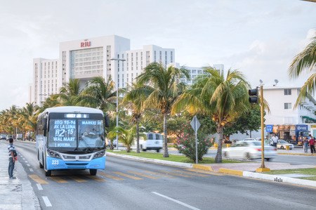 CANCUN, MEXICO - JANUARY 22, 2015: City bus and other vehicular traffic travel down Kukulkan Boulevard in the hotel zone of Cancunのeditorial素材