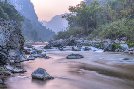 Slow shutter river water flowing over rocky streambed in tropical La Venta Canyon in Chiapas, Mexicoの写真素材