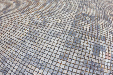 Wide angle fisheye view of outdoor patio floor consisting of different tones of small square tiles in Merida, Mexicoの写真素材