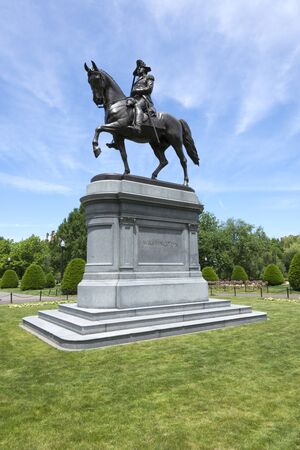 Beautiful bronze statue of George Washington at ornately landscaped Boston Common park in Boston, Massachusetts under clear sunny skyの写真素材