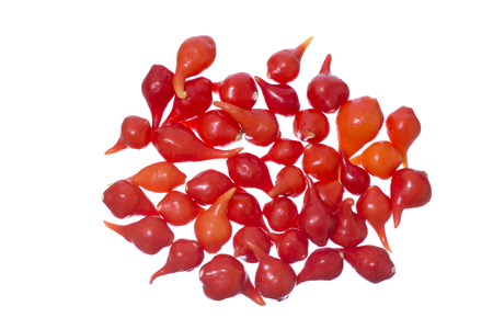 Closeup pile of small red hot chili peppers isolated on white backgroundの写真素材