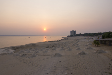 Mounds of beach sand along Rio Negro river at Ponta Negra near Manaus in the Amazon during beautiful sunsetの写真素材