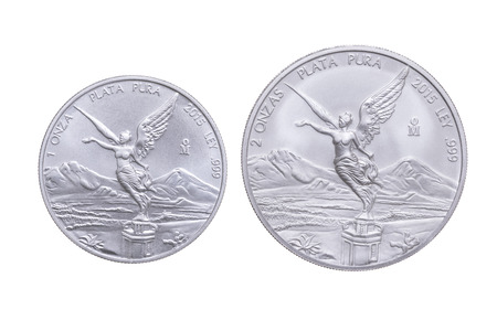 Side by side size comparison between one ounce and two ounce Mexican silver bullion libertad coins isolated on white backgroundの写真素材