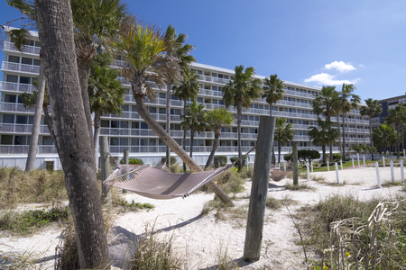 ST. PETE BEACH, FLORIDA, USA - FEBRUARY 25, 2016: Tradewinds Island Grand Resort on St. Pete Beach sits on the gulf side with white sandy beaches and hammocks between palm trees.のeditorial素材