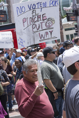 SAN DIEGO, USA - MAY 27, 2016: A Hispanic man holds an anti-Trump sign in Spanish asking voters not to vote for Trump outside a Trump rally in San Diego.のeditorial素材