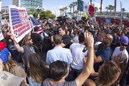 SAN DIEGO, USA - MAY 27, 2016: Media cameras frantically capture the action as anti-Trump protesters meet Trump supporters outside a Donald Trump rally at the San Diego Convention Center.のeditorial素材