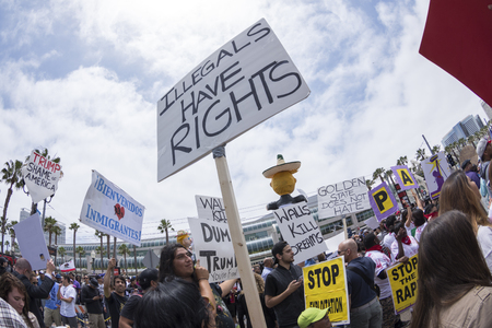 SAN DIEGO, USA - MAY 27, 2016: The Trump rally in San Diego attracts a huge crowd of protesters many of them carrying pro-immigrant signs such as this sign reading "Illegals have rights".のeditorial素材
