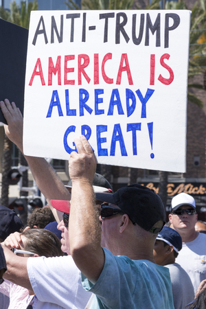 SAN DIEGO, USA - MAY 27, 2016: A Caucasian man holds an anti-Trump sign amidst a huge crowd of protesters outside a Trump rally at the San Diego Convention Centerのeditorial素材