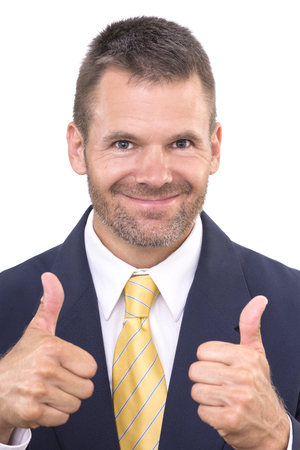 Closeup portrait of handsome and successful businessman smiling and giving two thumbs up on white backgroundの写真素材