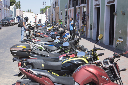 VALLADOLID, YUCATAN, MEXICO - FEBRUARY 24, 2017: Inexpensive motorbikes are the personal means of transportation choosen by many citizens in Mexicoのeditorial素材