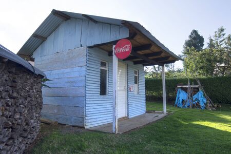 SAN JUAN CHAMULA, CHIAPAS, MEXICO - JUNE 23, 2018: Throughout Mexico it is common to find very small mom and pop shops like this rustic blue store selling snacks and refreshments such as the popular Coca-Cola products.のeditorial素材