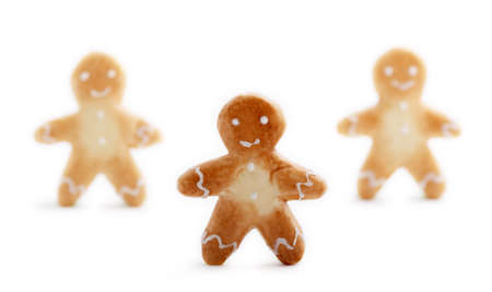 Three cute gingerbread men cookies with soft shadows isolated on white background