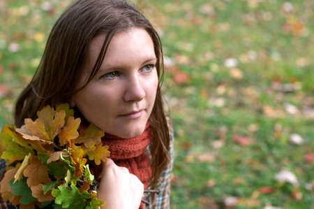 Beautiful young woman in the park at sunny fall day の写真素材