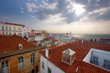 Bird view of central Lisbon with colorful houses and orange roofs