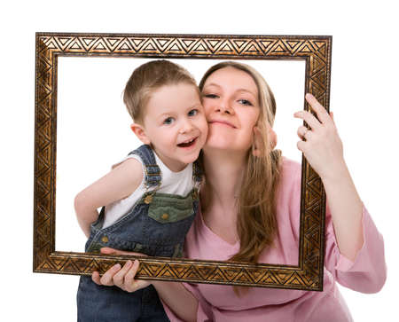 Casual portrait of mother and son having fun together playing with frame. Isolated on whiteの写真素材