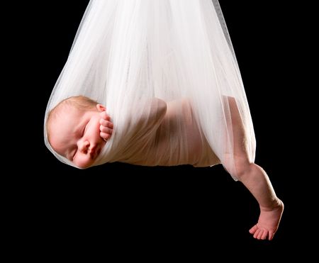 Stork Baby Package. 14 days old newborn baby girl carried in white clothの写真素材