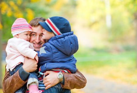 Young father with two kids enjoying beautiful autumn dayの写真素材