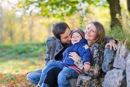 Young family enjoying beautiful autumn day