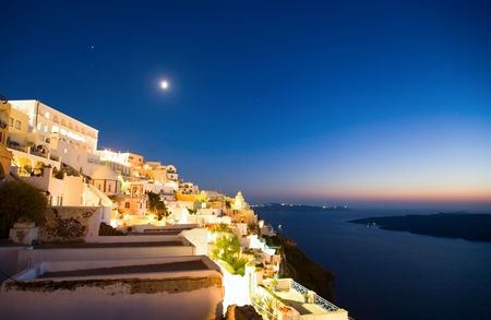 Fira main village of greek island Santorini and spectacular caldera by nightの写真素材