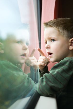 Cute 4-years old boy traveling by trainの写真素材
