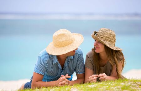 Young happy couple on white sand beachの写真素材