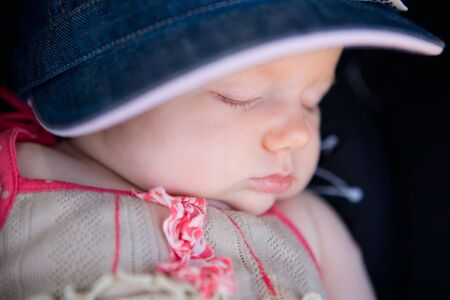 Portrait of cute 2 months old sleeping baby girl outdoorの写真素材