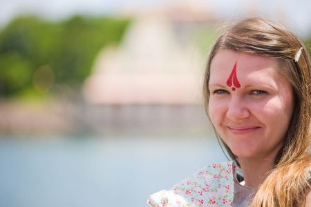 Young Caucasian woman with Hinduism symbol on forehead.