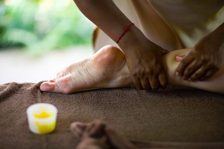 Therapist making spa reflexology foot massageの写真素材