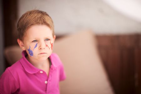 Small boy having his face painted