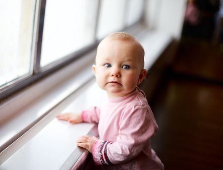 Lifestyle portrait of cute 1 year old girl