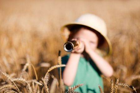 Portrait of young nature explorer in wheat fieldの写真素材
