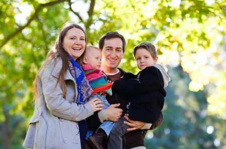 Young family with two kids enjoying beautiful autumn dayの写真素材