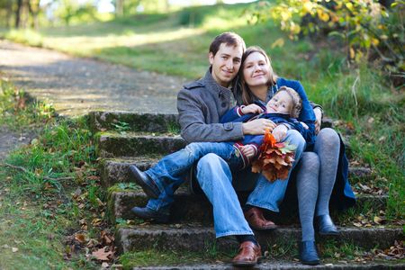 Young family enjoying beautiful autumn dayの写真素材