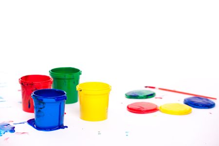 Closeup of colorful finger paints over white backgroundの写真素材