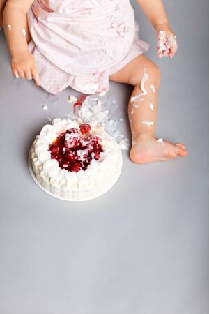 Closeup of  little girl eating her first birthday cakeの写真素材