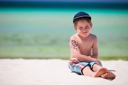 Cute 5 years old boy on tropical beachの写真素材