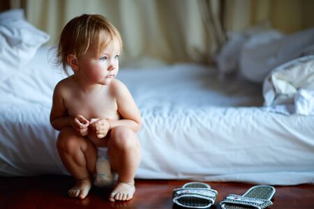 Adorable toddler girl in bedroom at the morningの写真素材