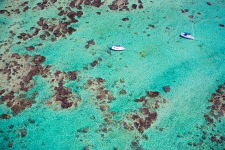 Aerial view of small boats in turquoise waters of Indian oceanの写真素材