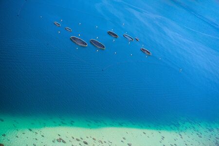 Aerial view of fish farm in turquoise waters of Indian oceanの写真素材