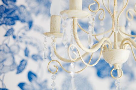 Vintage lamp closeup in nicely decorated bedroom in blue and white colorsの写真素材
