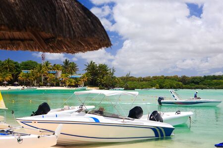 Some small boats at tropical beach resortの写真素材
