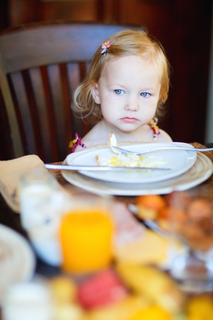 Portrait of adorable toddler girl eating breakfastの写真素材