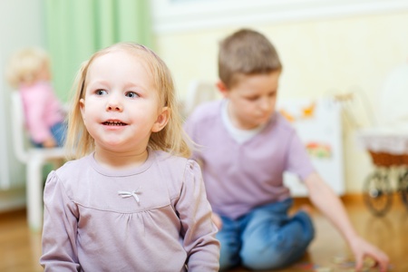 Two little kids at home or daycareの写真素材