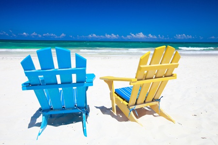 Colorful wooden chairs on beach at Caribbean coastの写真素材