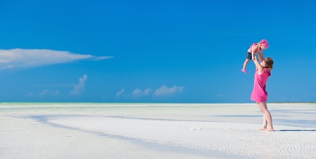 Mother and her little daughter enjoying Caribbean beach vacationの写真素材