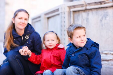 Portrait of mother and two kids outdoors at autumn dayの写真素材
