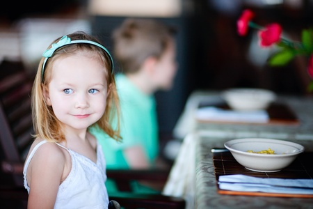 Portrait of adorable little girl at restaurantの写真素材