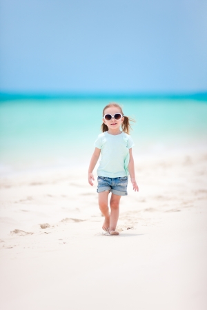 Adorable little girl walking at Caribbean beachの写真素材